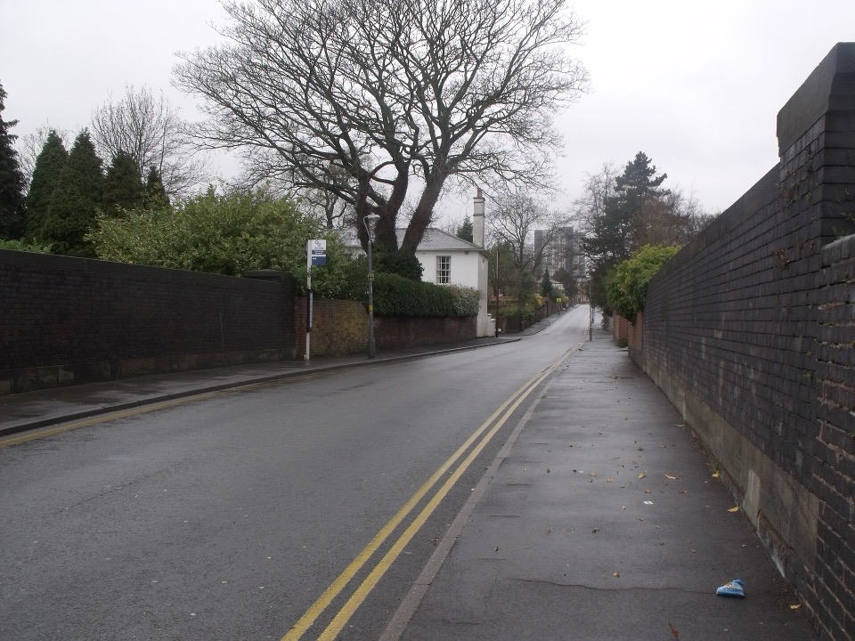 St James Road in Edgbaston, Birmingham, a quiet street with a white lodge house behind brick walls