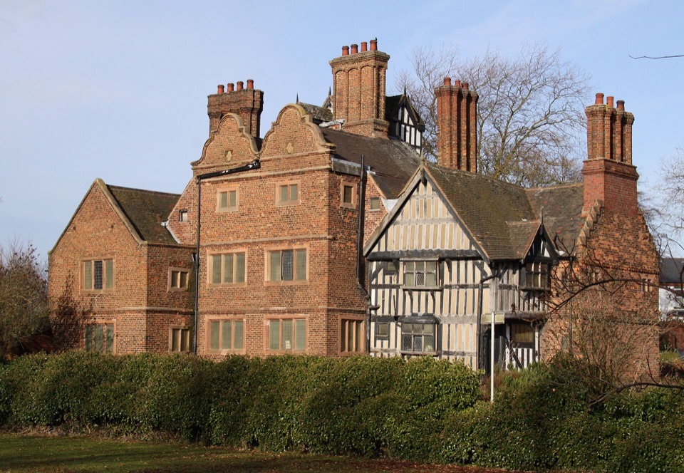 Oak House, a Tudor timber-framed merchant house with tall brick chimneys in West Bromwich
